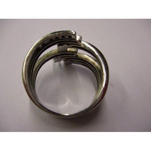 68 - An 18ct white gold and diamond ring in a stylised coil form