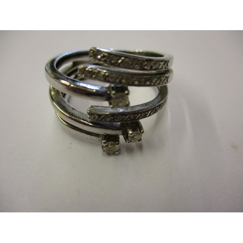 68 - An 18ct white gold and diamond ring in a stylised coil form