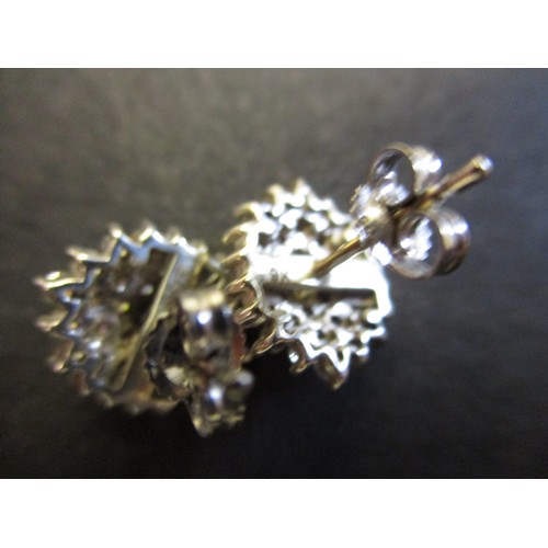 69 - A pair of 9ct white gold and diamond earrings