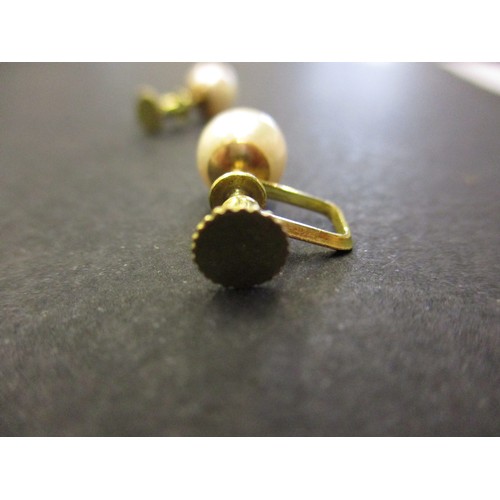 72 - A pair of 585 gold and cultured pearl screw on earrings