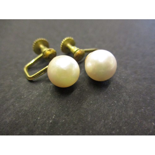 72 - A pair of 585 gold and cultured pearl screw on earrings