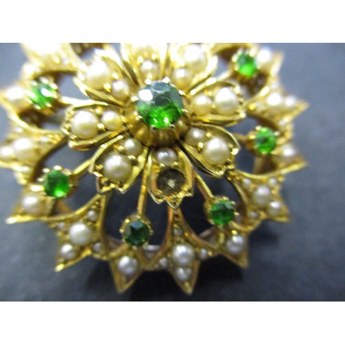 73 - A 15ct yellow gold brooch set with seed pearls and emerald green stones