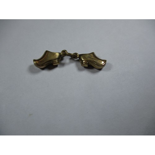 74 - A 9ct gold charm in the form of a pair of shoes, approx weight 0.8g