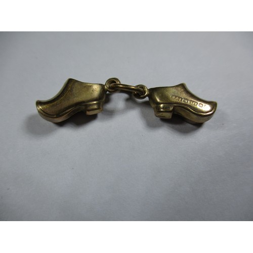 74 - A 9ct gold charm in the form of a pair of shoes, approx weight 0.8g