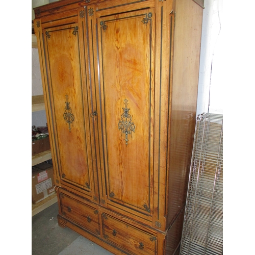 391 - An antique pine/fruitwood double wardrobe with 2 drawer base