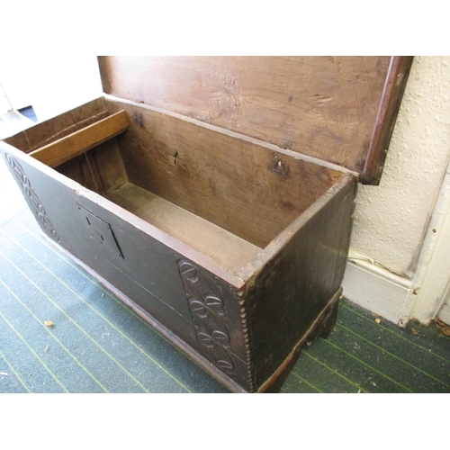 385 - An antique elm coffer having original lock and hinges, carving to front panel.