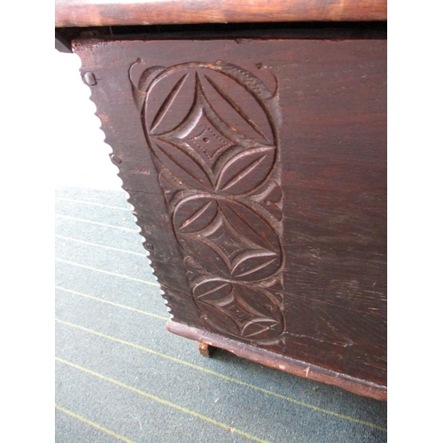 385 - An antique elm coffer having original lock and hinges, carving to front panel.