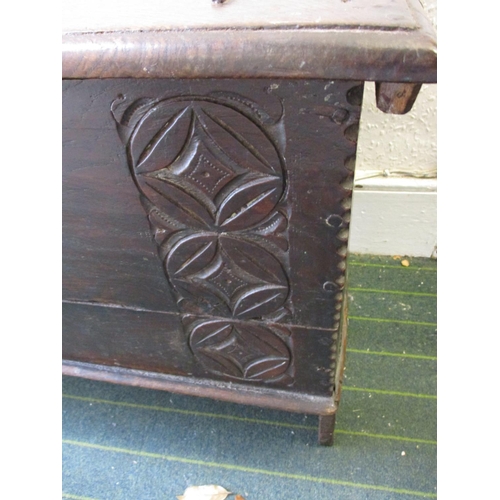 385 - An antique elm coffer having original lock and hinges, carving to front panel.