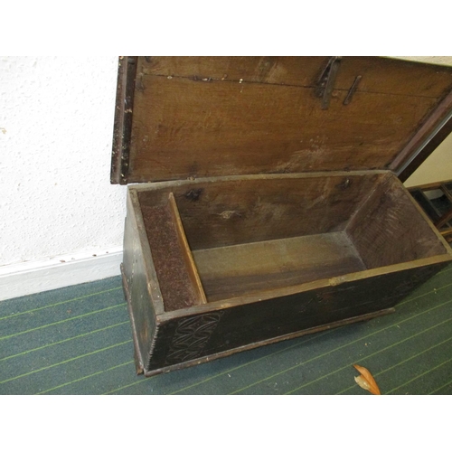 385 - An antique elm coffer having original lock and hinges, carving to front panel.