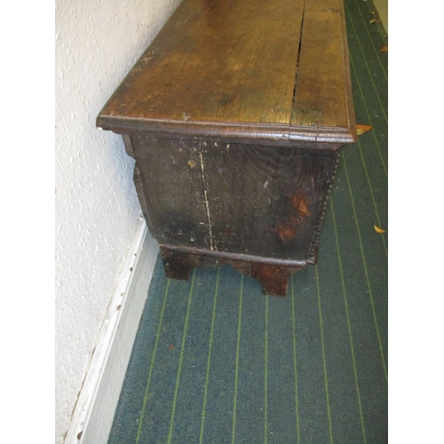 385 - An antique elm coffer having original lock and hinges, carving to front panel.