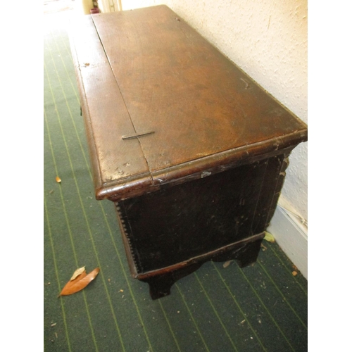 385 - An antique elm coffer having original lock and hinges, carving to front panel.