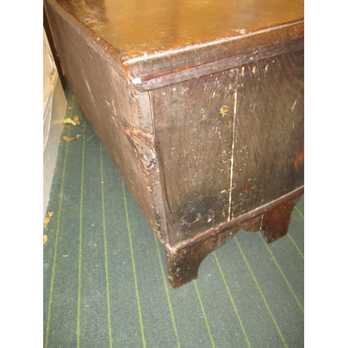 385 - An antique elm coffer having original lock and hinges, carving to front panel.