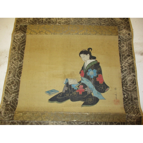 375 - A Japanese scroll painting, signed Hanabusa Itiho, in ink and colours depicting a bijin reading a bo... 