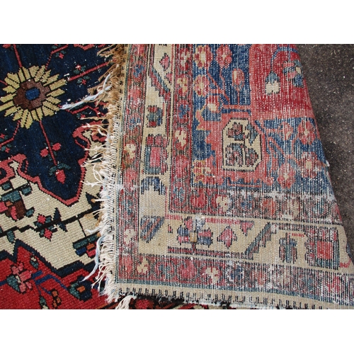 343 - A vintage Persian hand knotted wool rug, in well used condition