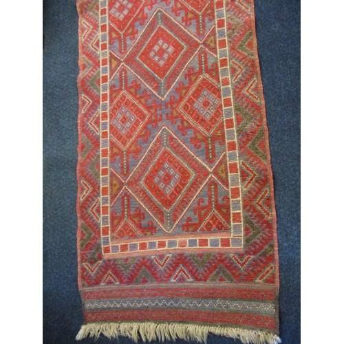 336 - A vintage Persian hand knotted wool runner, having a red ground with geometric design