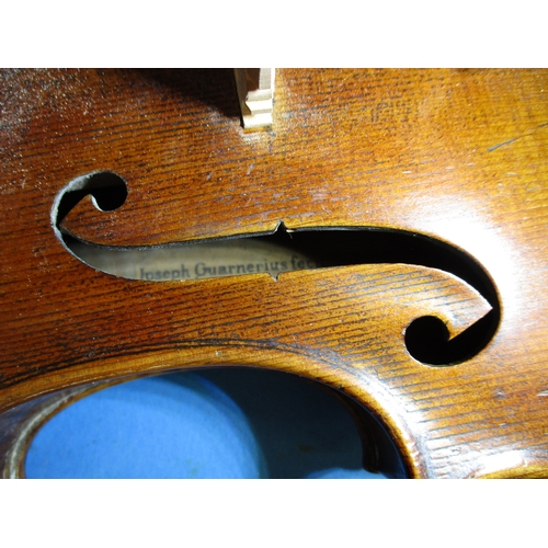 284 - An early 20th century violin in hard case with 3 bows