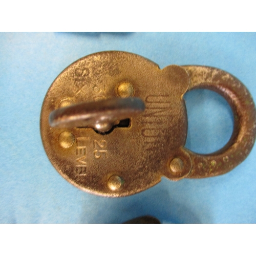 296 - A collection of vintage padlocks, each with a key