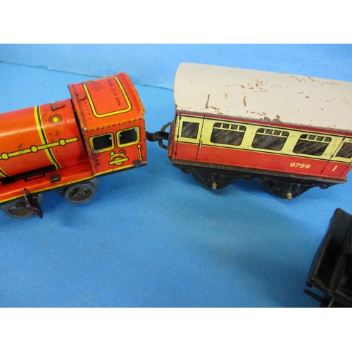 277 - Two Hornby clockwork engines and 2 vans, in working order