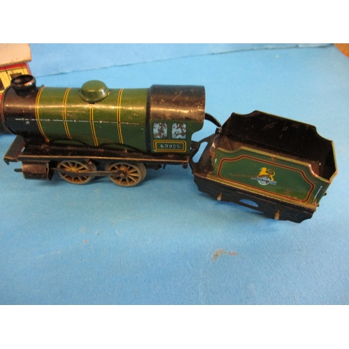 277 - Two Hornby clockwork engines and 2 vans, in working order