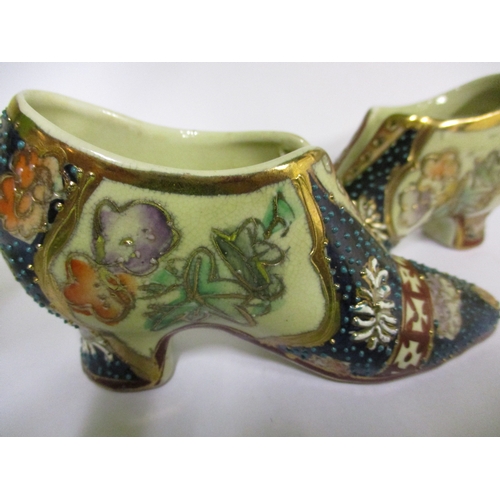 255 - Two vintage miniature oriental porcelain shoes, with polychrome tubeline decoration