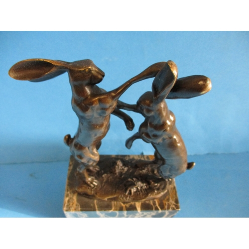 243 - A cast bronze sculpture of dancing hares, signed to base NICK