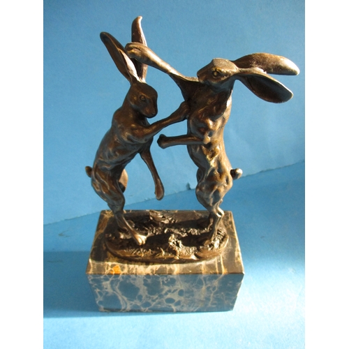 243 - A cast bronze sculpture of dancing hares, signed to base NICK