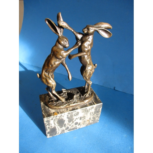 243 - A cast bronze sculpture of dancing hares, signed to base NICK