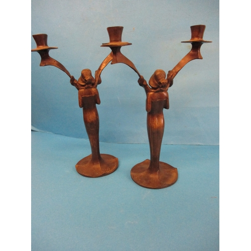 247 - A pair of bronze art nouveau candlesticks, signed to base