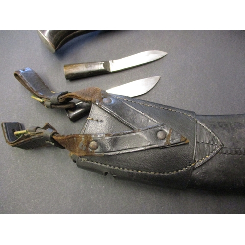 225 - A WWII Kukri with inlaid handle complete with scabbard and knives