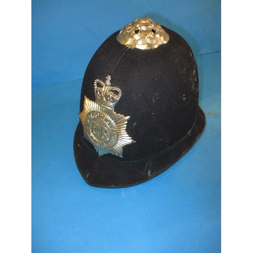 213 - Two vintage army helmets, a Military police helmet and a Metropolitan police helmet