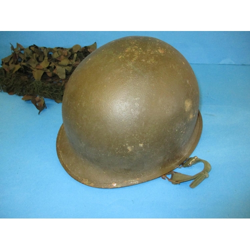 213 - Two vintage army helmets, a Military police helmet and a Metropolitan police helmet