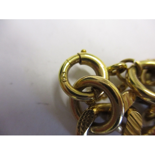 98 - A heavy 9ct gold embossed curb link bracelet. With working clasp and safety chain. Approximate weigh... 