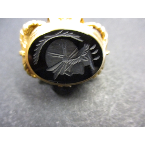 103 - A large 9ct gold intaglio stone seal charm. Approximate total weight 16.8g