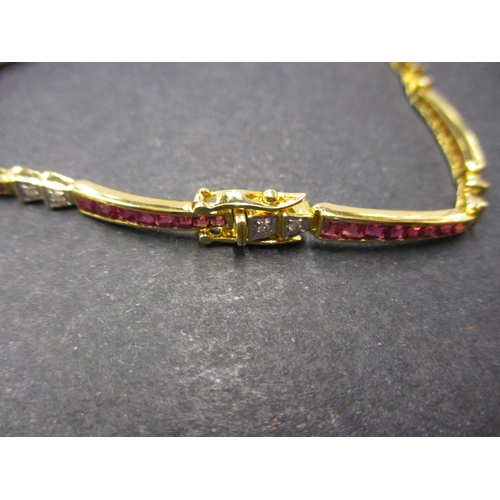 109 - An 18ct gold bracelet set with rubies and diamonds