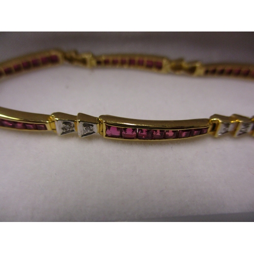 109 - An 18ct gold bracelet set with rubies and diamonds