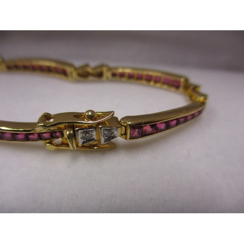 109 - An 18ct gold bracelet set with rubies and diamonds