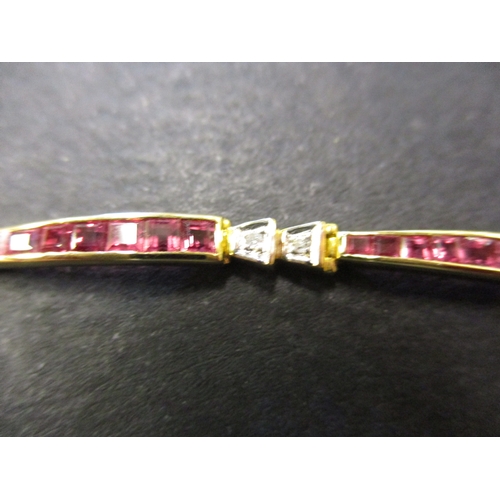 109 - An 18ct gold bracelet set with rubies and diamonds