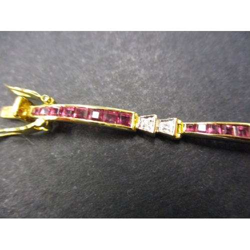 109 - An 18ct gold bracelet set with rubies and diamonds