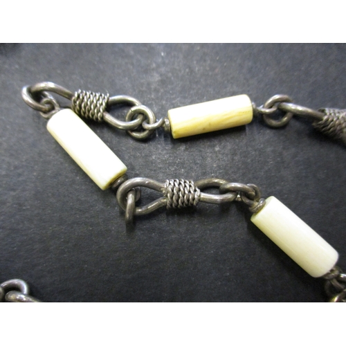 123 - Two vintage African white metal and bone necklaces