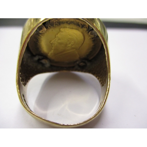 131 - A 9ct gold signet ring set with a 1981 quarter Krugerrand