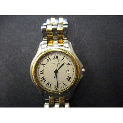 150 - A vintage Cartier quartz watch with ancillary date dial, in good working order