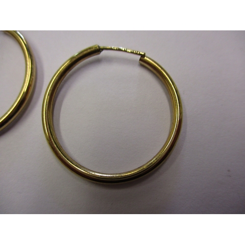 153 - A pair of 9ct gold hoop earrings, approx. weight 2.6g