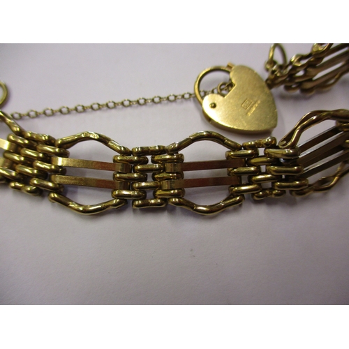 155 - A 9ct yellow gold bracelet with working heart clasp and safety chain, approx. weight 20g