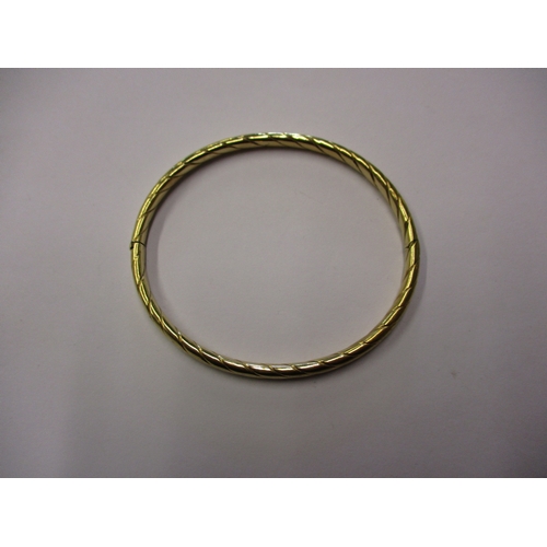 157 - A 9ct gold wrist bangle, approx. weight 7.5g,