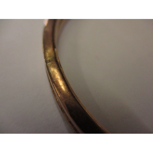 158 - A 9ct gold wrist bangle, approx. weight 9.3g