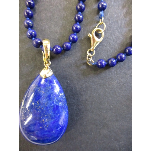 164 - A Lapis lazuli bead necklace with gold mounts and a 9ct gold necklace with a rose quartz pendant