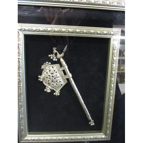 182 - An oriental white metal presentation piece in glazed frame