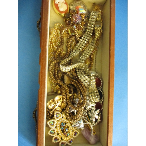 193 - A jewellery box with contents of costume jewellery to include a gold mounted necklace pendant