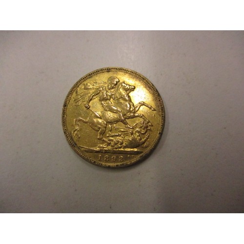 103 - An Victorian gold full sovereign dated 1893, with a loose 9ct gold mount,