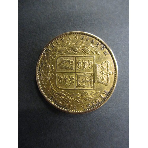 109 - A Victorian young head shield back sovereign dated 1863, in pre-owned condition with general age-rel... 